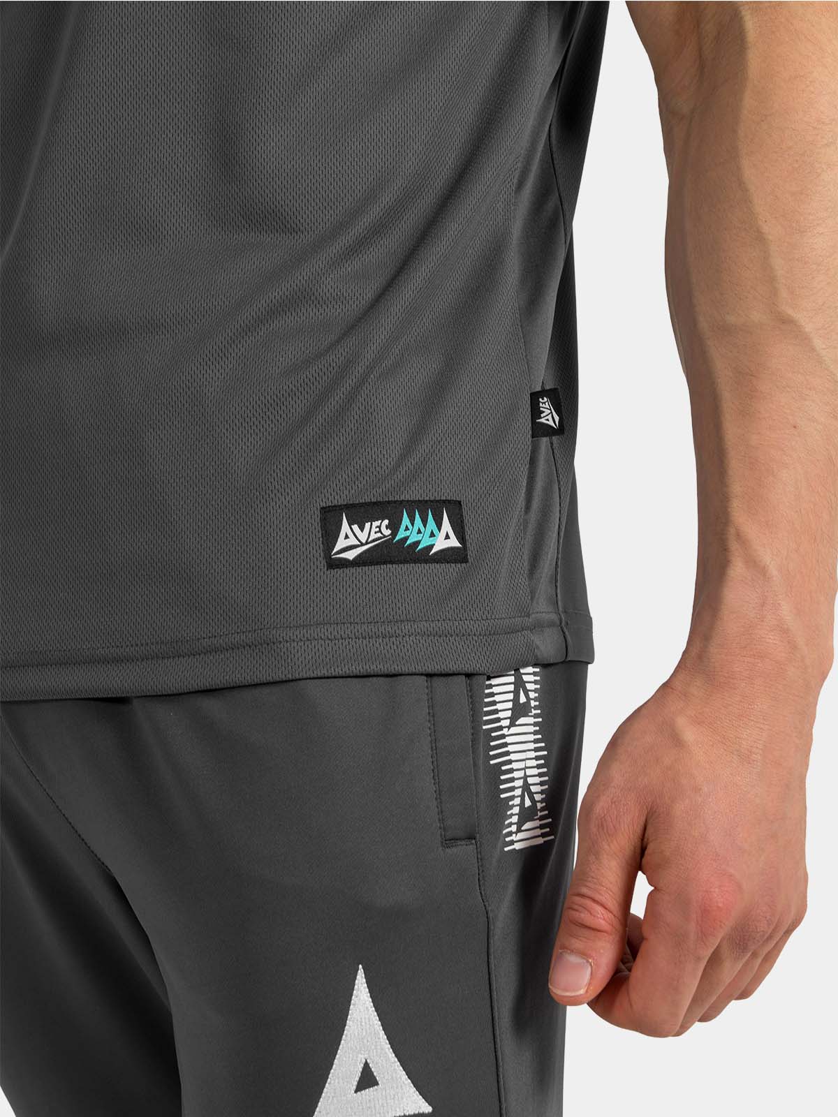 	detailed shot of the anthracite polo hem, authentic id label, and mesh ventilation.