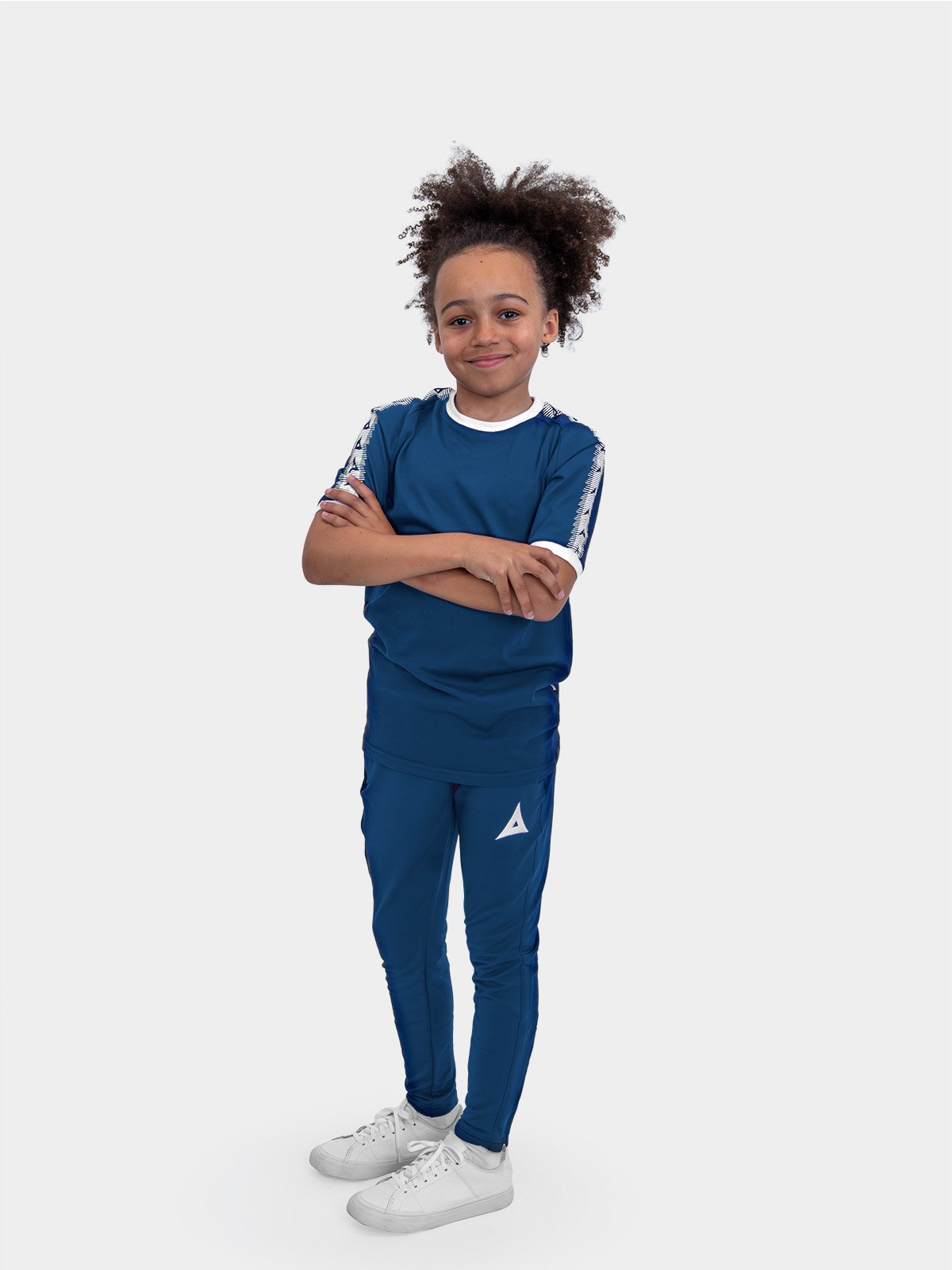 a junior male model wearing the avec evolve navy t-shirt with ribbed sleeve cuff and neck in white and matching navy avec focus 2 track pants