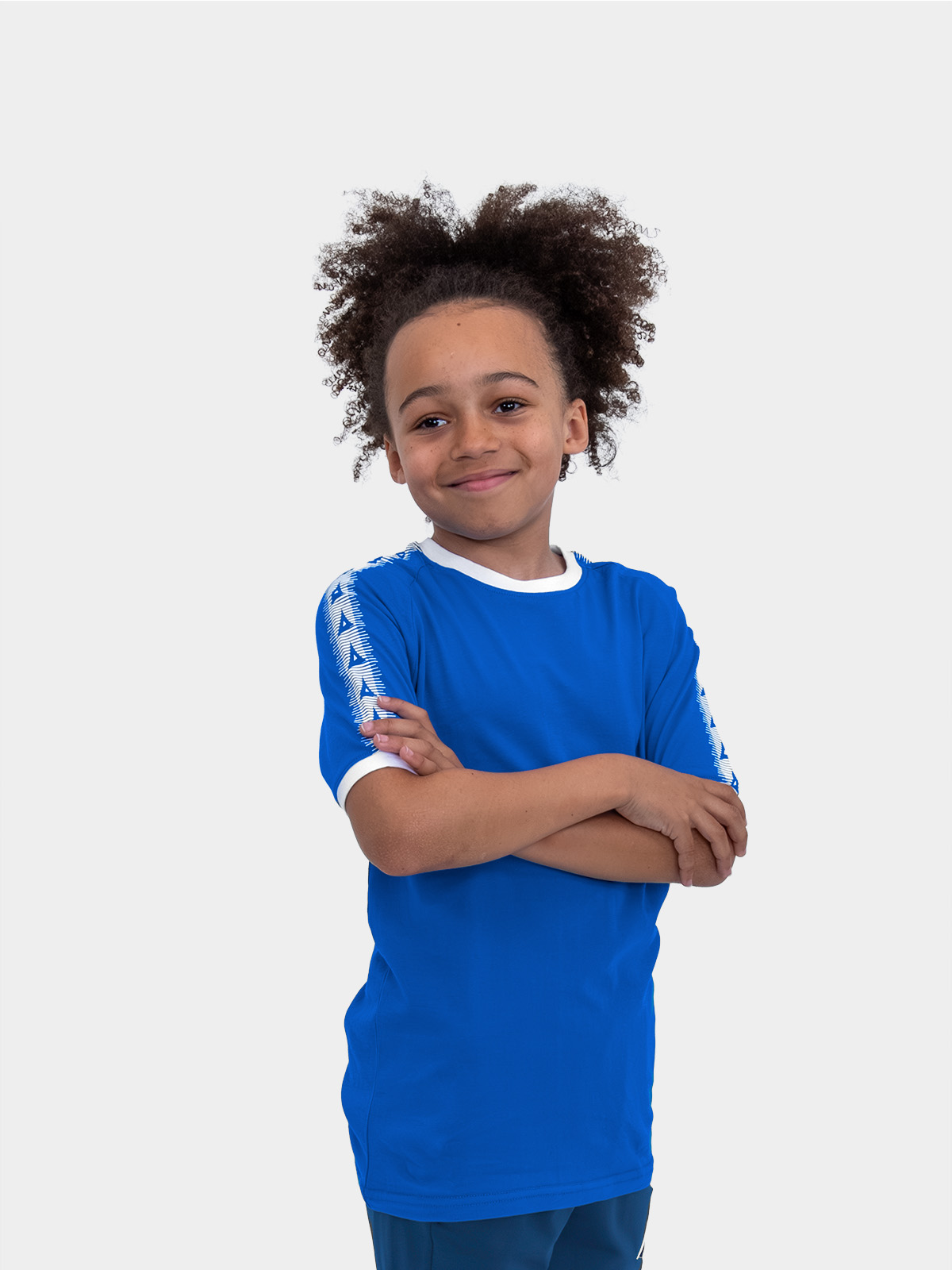 a boy is stood wearing wearing the avec evolve royal blue t-shirt, plain royal blue top with sleeve detail