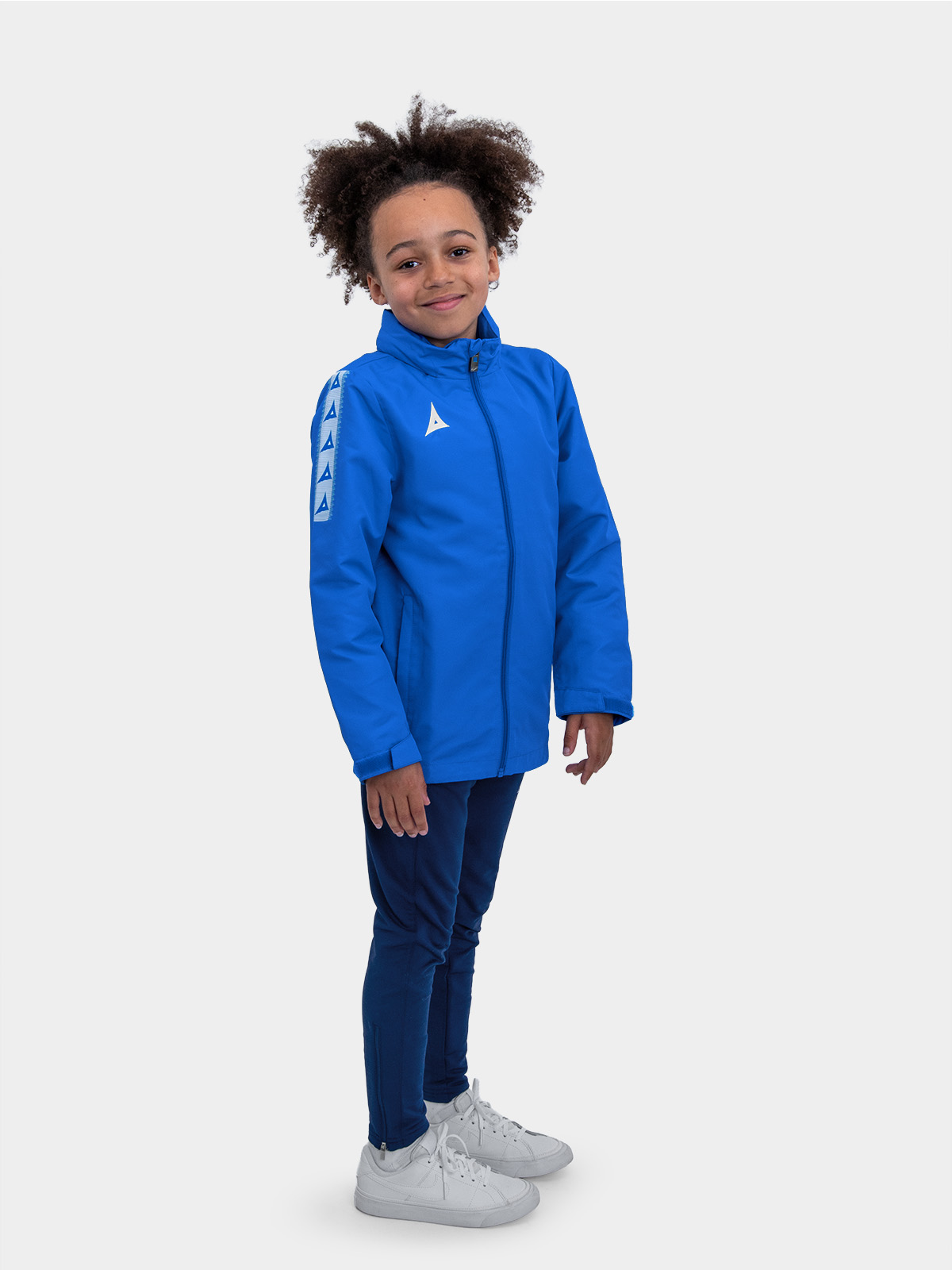 	full length junior shot in royal blue football rain jacket showing fit across junior size range