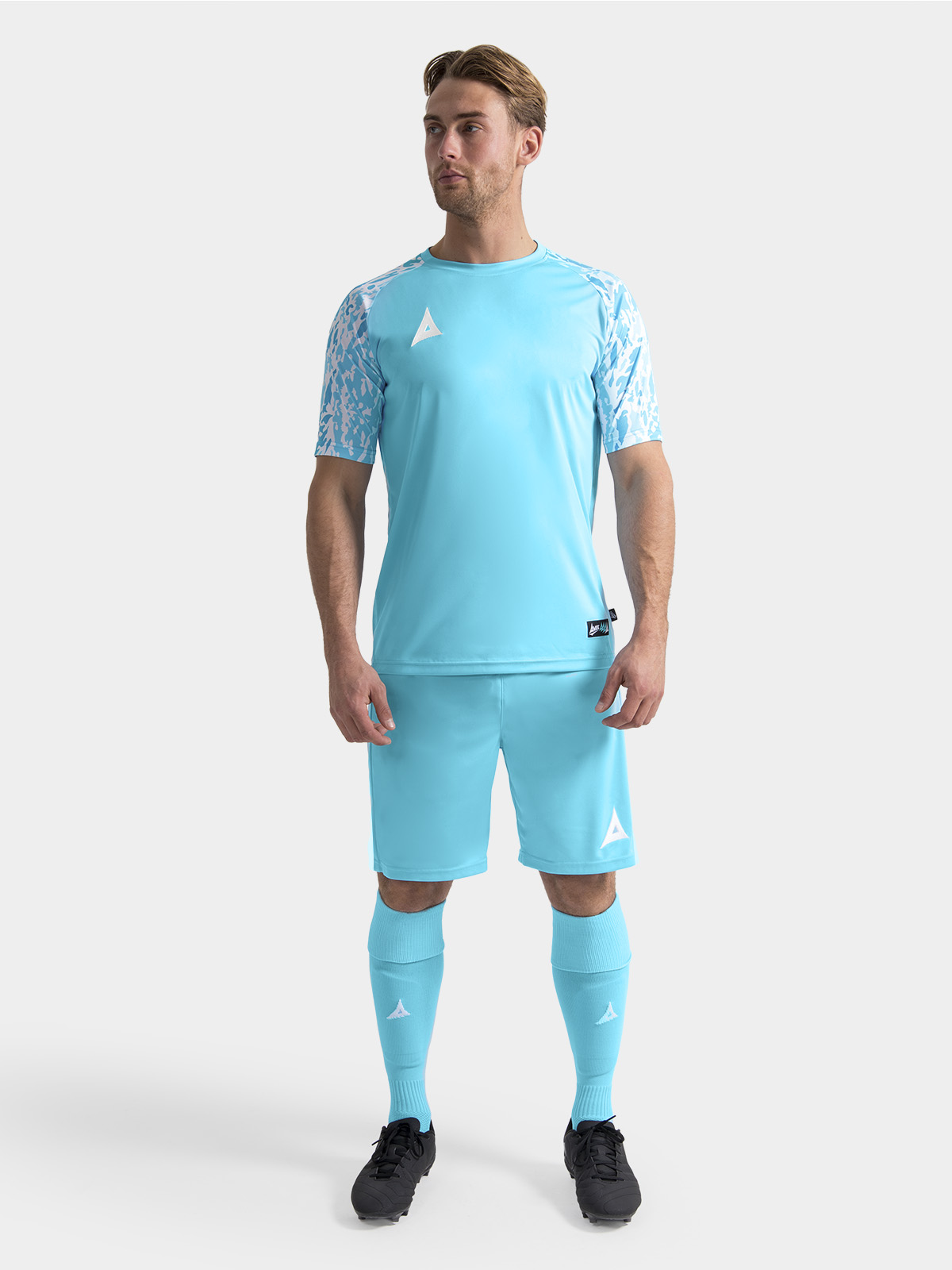 	full matchday kit view of the hyper sky jersey on-model, paired with matching professional teamwear shorts and socks.