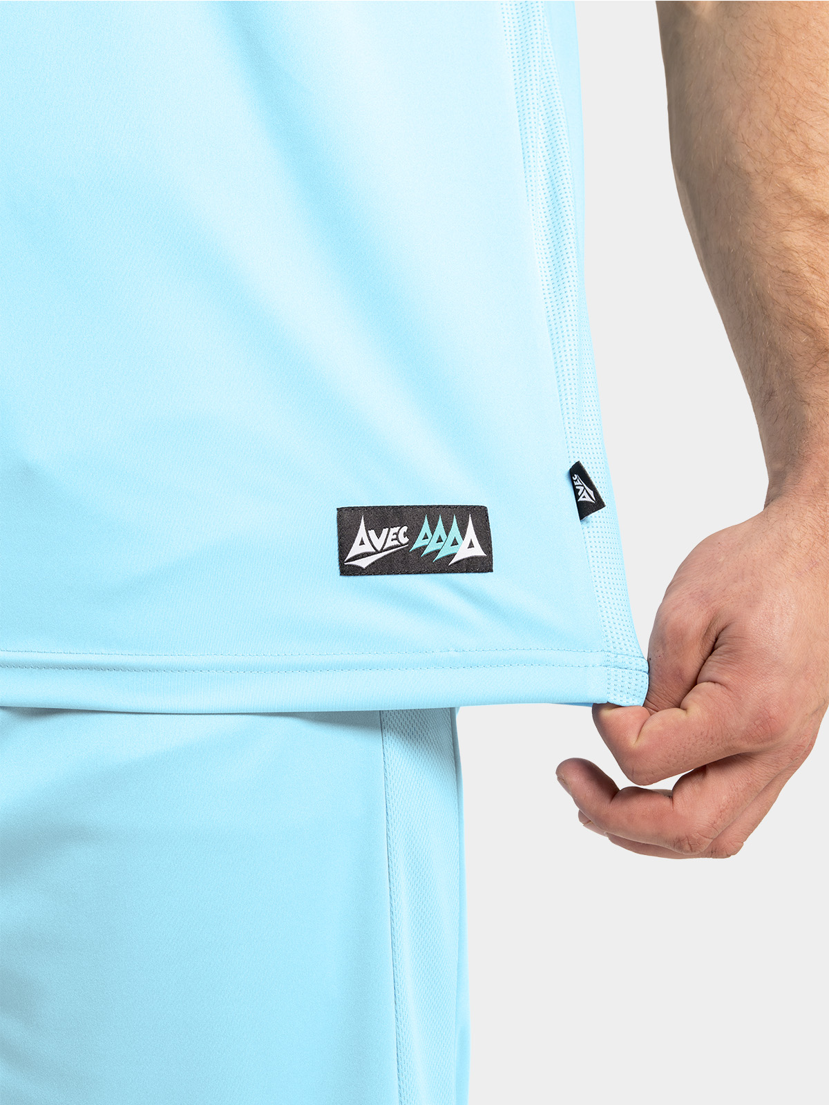 lower hem detail of the hyper sky jersey, featuring the breathable mesh ventilation and official woven authenticity label.