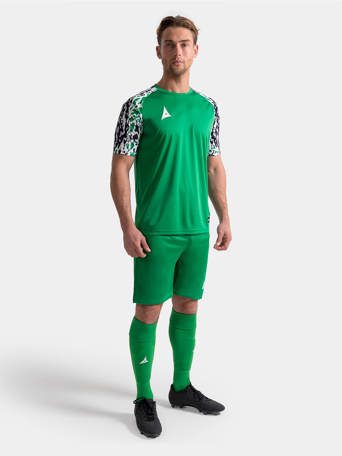 	full body view of the green classic pro kit on-model, demonstrating a unified professional appearance.