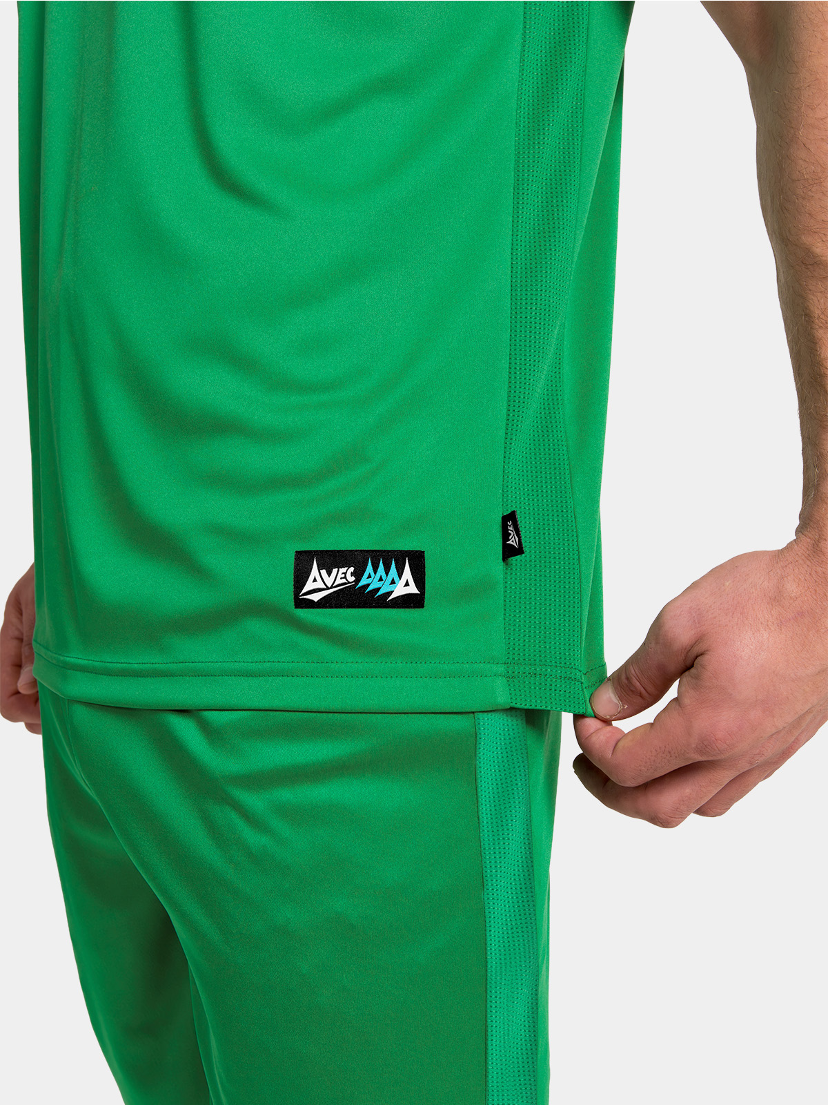 	close-up of the side seam ventilation mesh and the silver authentic woven label on the green jersey
