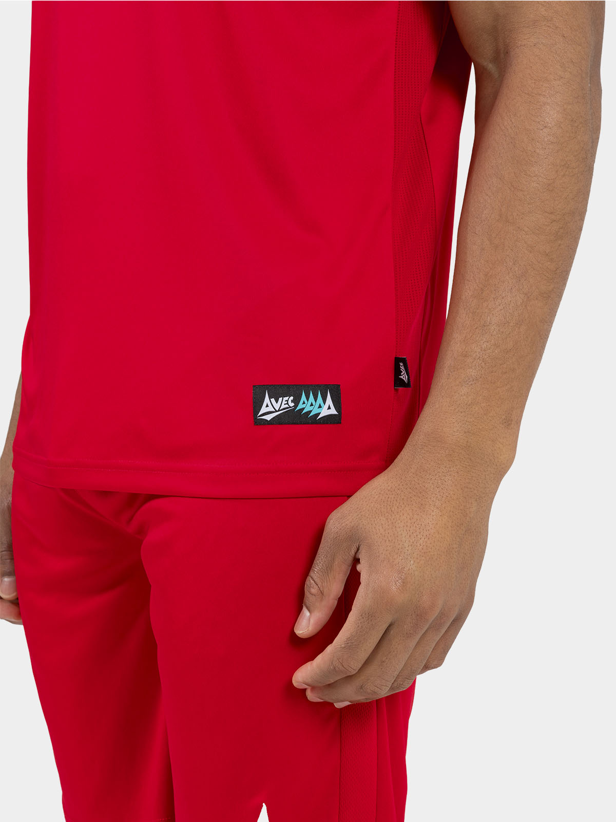 	side hem view of the red jersey, showing the official authenticity label and moisture-wicking mesh.