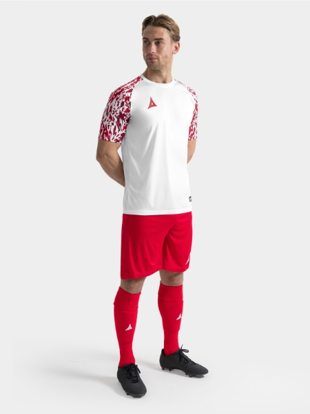 	Full matchday kit view featuring the White and Red jersey styled with matching teamwear shorts and socks.