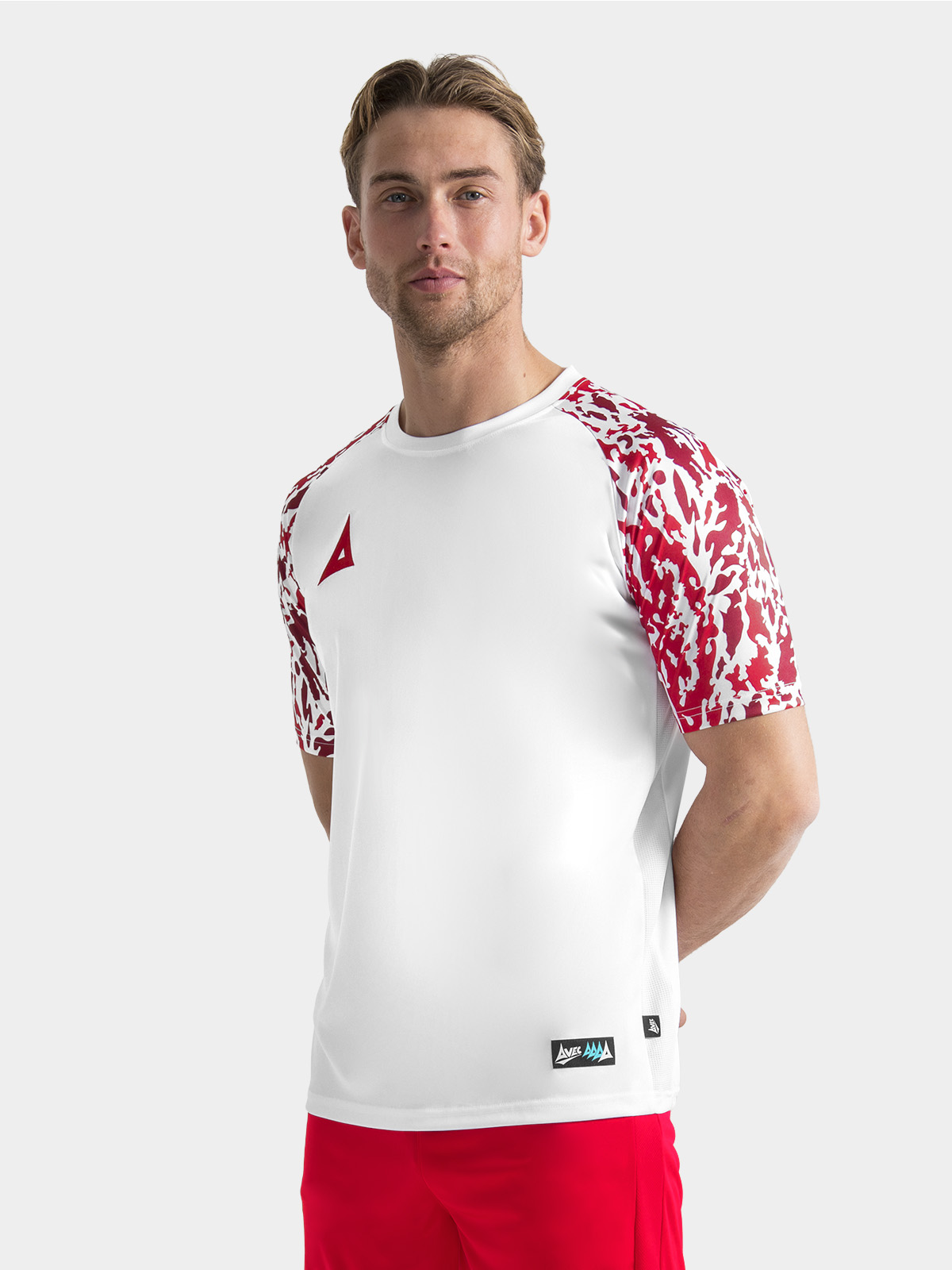	professional athlete wearing the white and red classic pro jersey, illustrating the athletic performance fit.