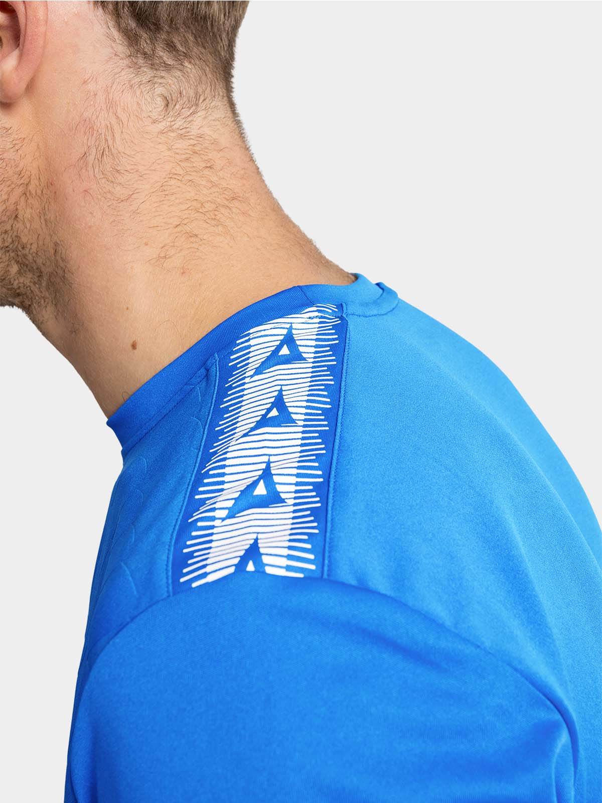 	close-up of the royal blue shoulder, detailing the contrast white heritage 'a' logo tape