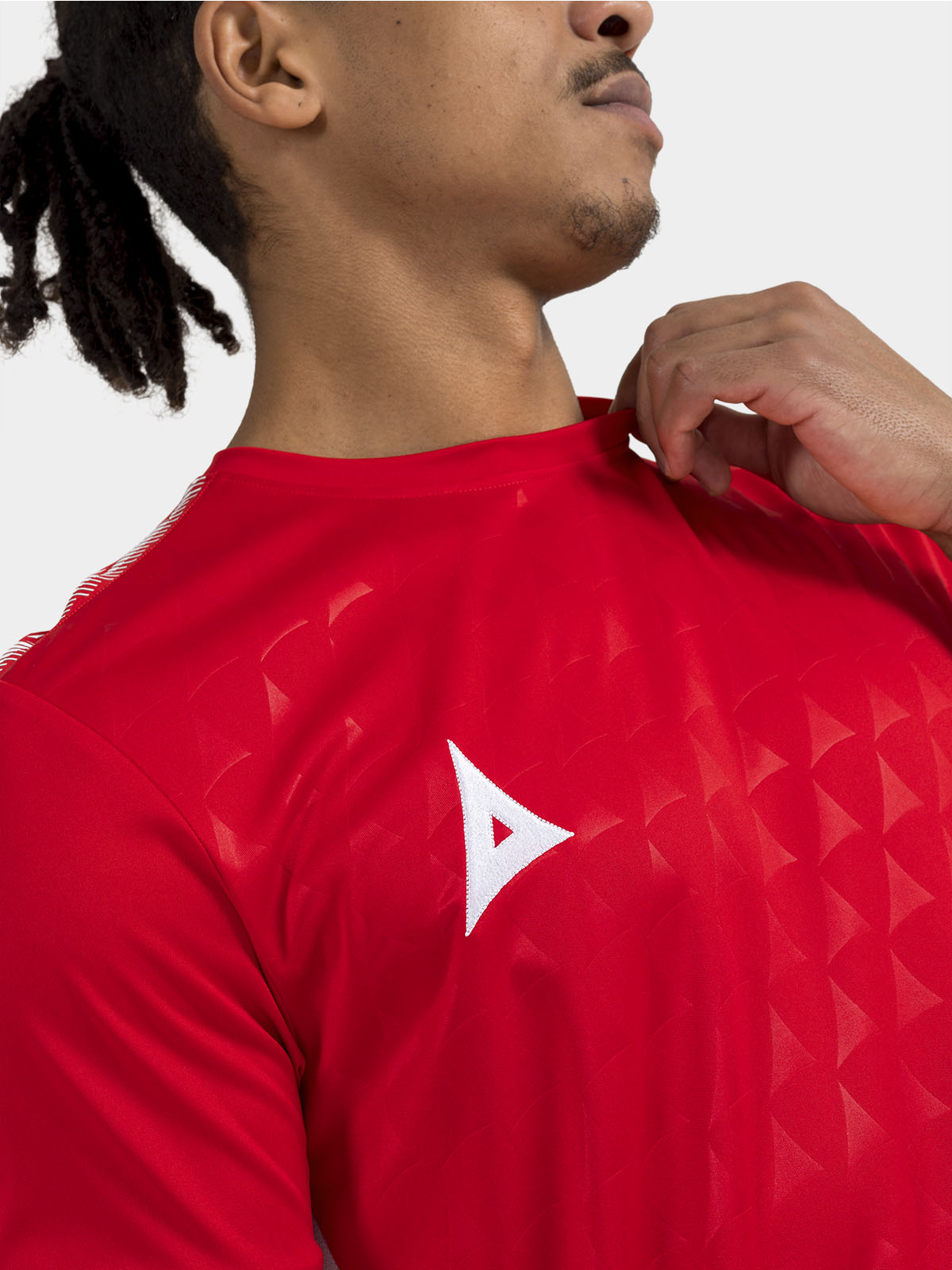 	close up shot of the repeating debossed 'a' logo pattern on the red front panel.