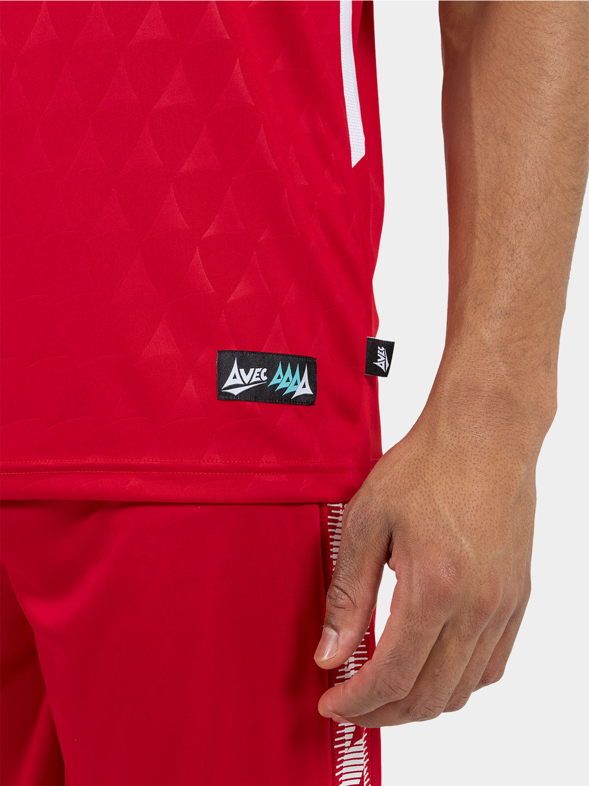 	close-up of the red jersey hem, showcasing the official authentic label and mesh ventilation.