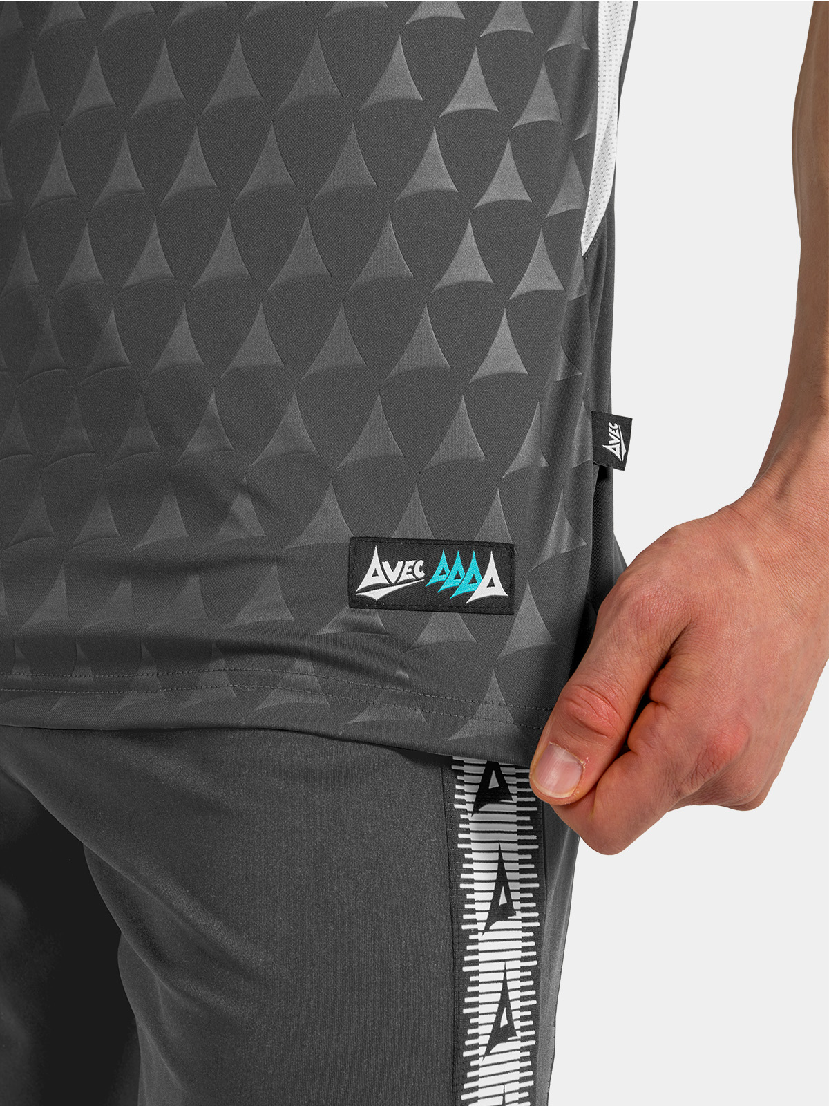 	detailed view of the anthracite jersey hem, showing the mesh side-seam and authentic woven label.	