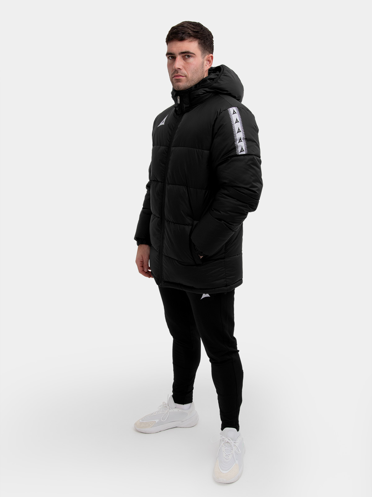 	black padded football jacket with hood and sleeve branding – designed to be worn pitchside by grassroots player in teamwear style