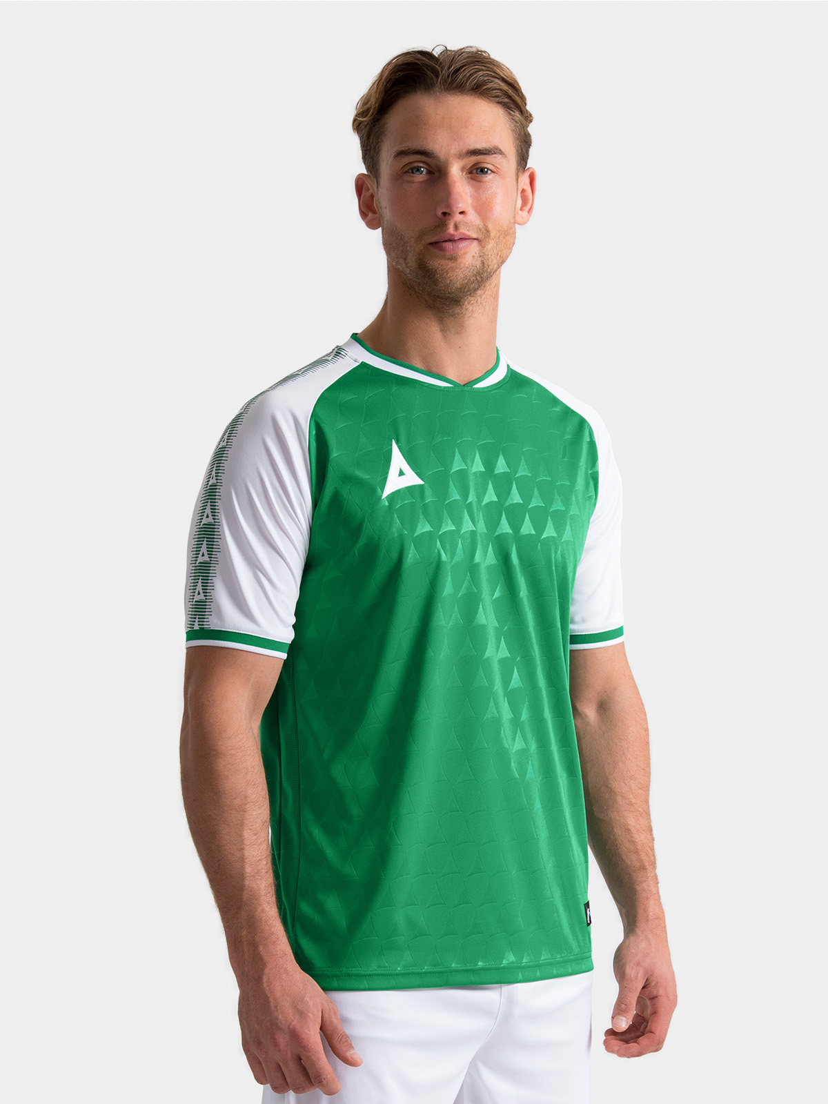 	lifestyle shot of the green and white heritage jersey showing the premium debossed fabric on-model.