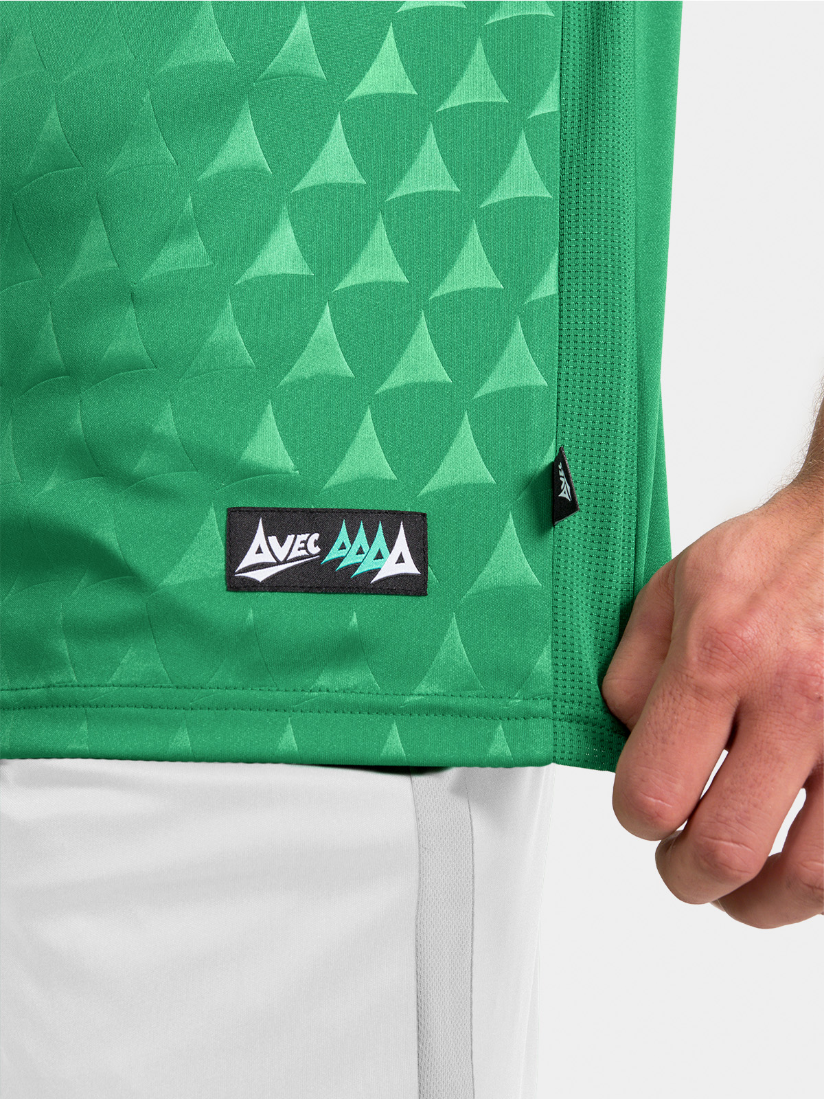 	hem detail of the green heritage jersey showing the official authenticity tab.	