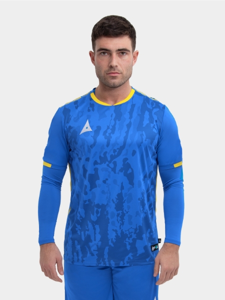 	A model standing up wearing a royal blue football shirt with a compression underlay in royal blue and yellow details