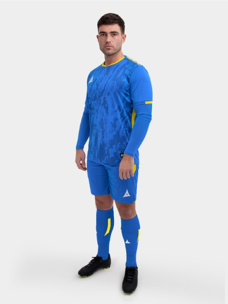 	A model standing up wearing a royal blue and yellow football shirt, blue Shorts and blue Football Socks.