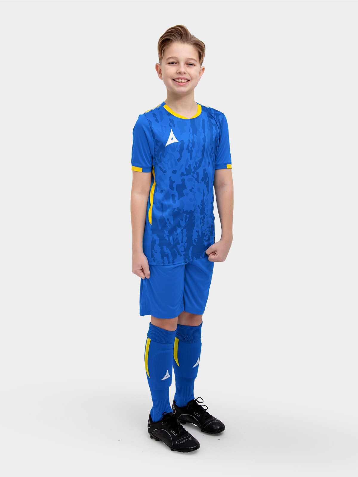	a model standing up wearing a royal blue football shirt, with yellow details