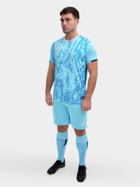 	A model standing up wearing a sky and navy football shirt, sky Shorts and sky Football Socks.