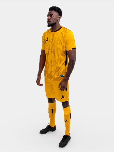 	A model standing up wearing an amber and black football shirt, amber Shorts and amber Football Socks.