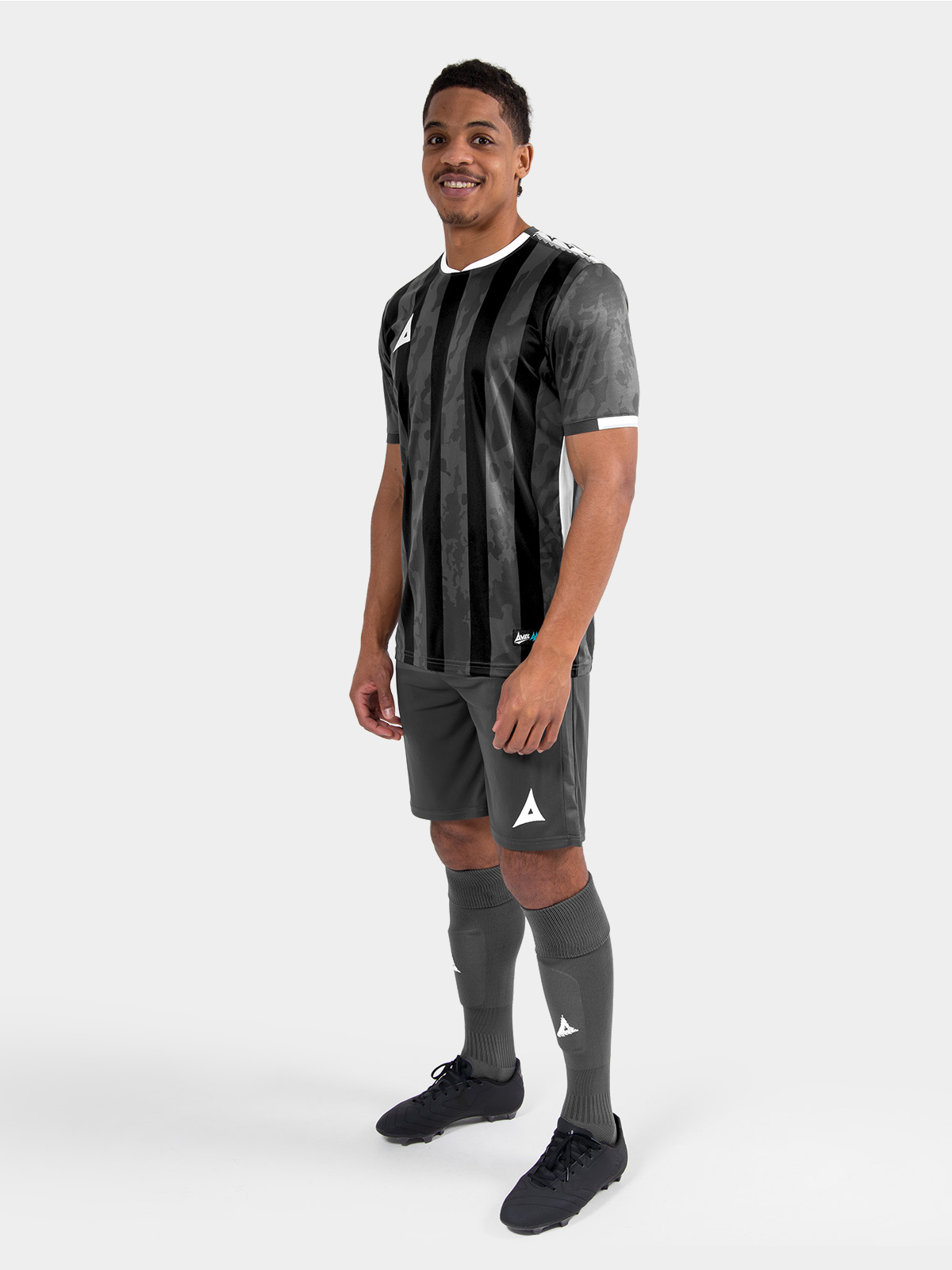 	full-body matchday look of the dark grey and black striped teamwear jersey, delivering a premium aesthetic for amateur teams.	