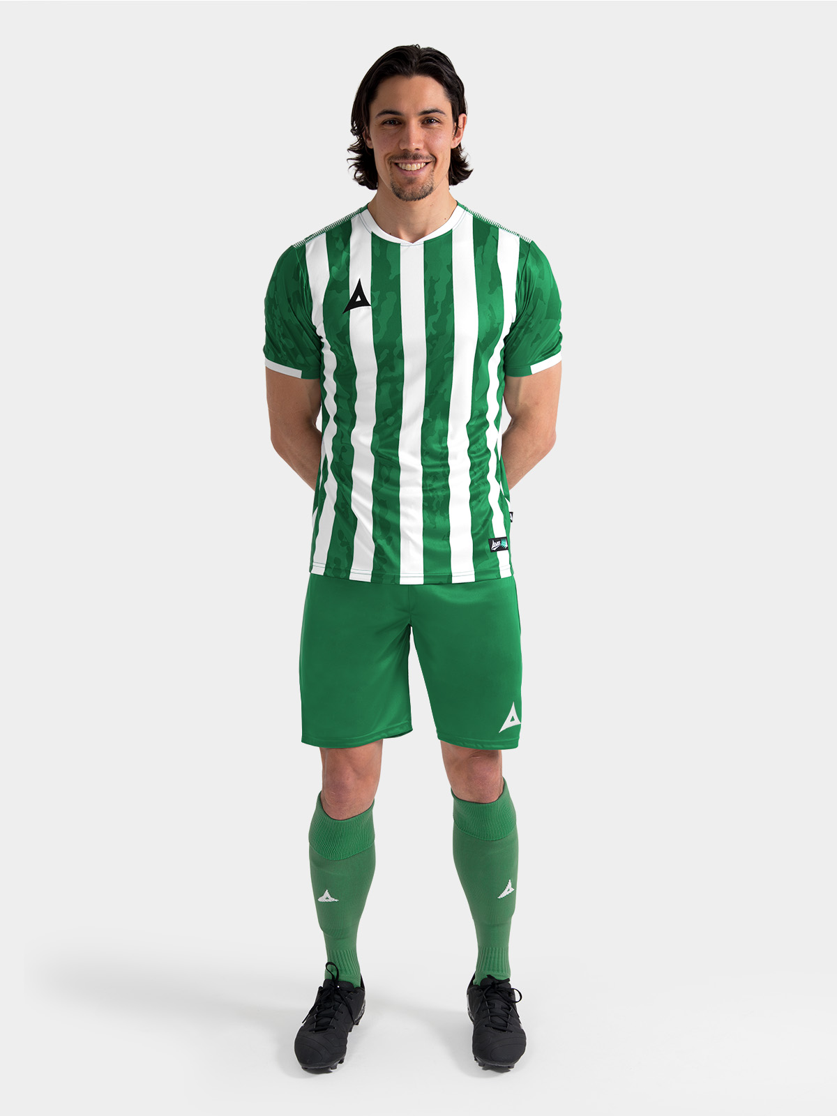 	full matchday look of the green and white pro intent stripe jersey, offering a professional aesthetic for amateur teams.