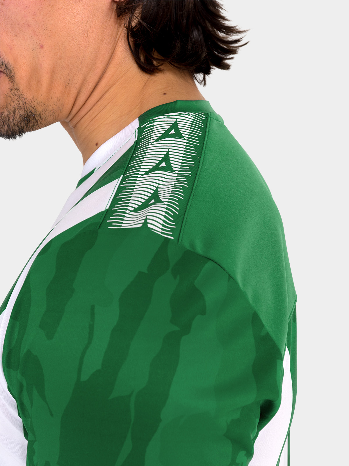 	close-up of the contrast heritage ‘a’ design on the shoulder of the green and white pro intent kit.