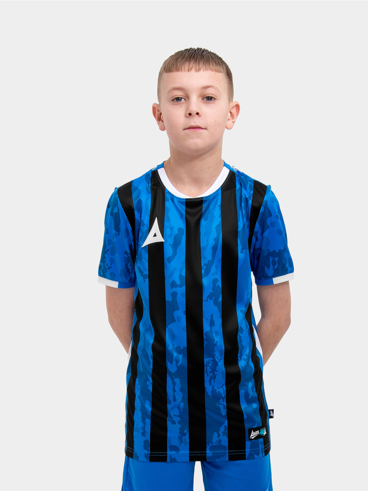 	a young child is wearing a royal blue and black striped football shirt. the football shirt has a camo pattern