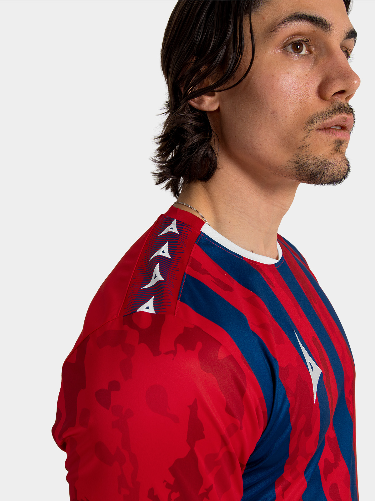 	close-up of the crisp white contrast design on the shoulder of the red and navy pro intent football kit.