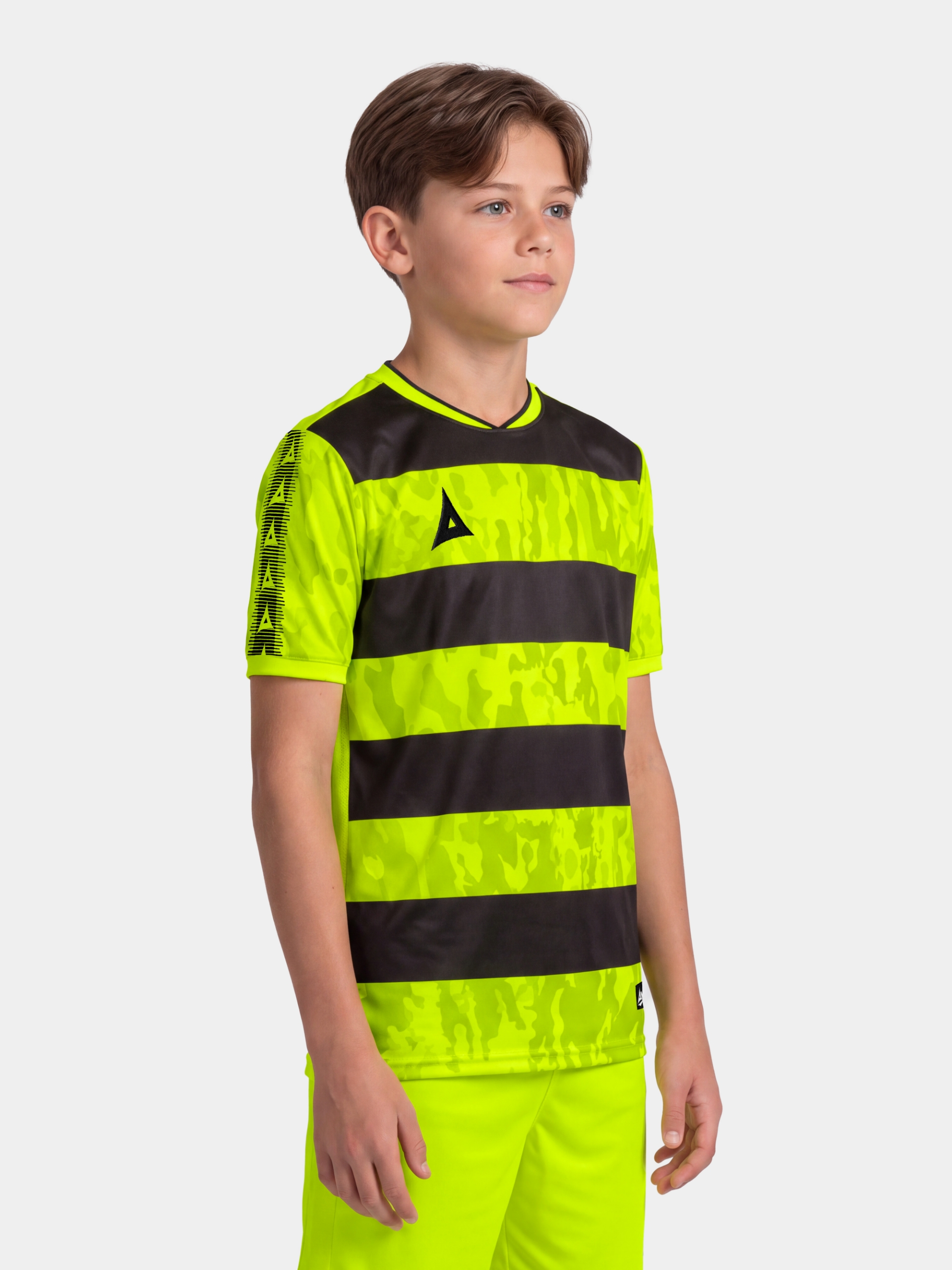 	young boy wearing the neon yellow and black pro intent jersey, highlighting the bold, high-energy matchday style.