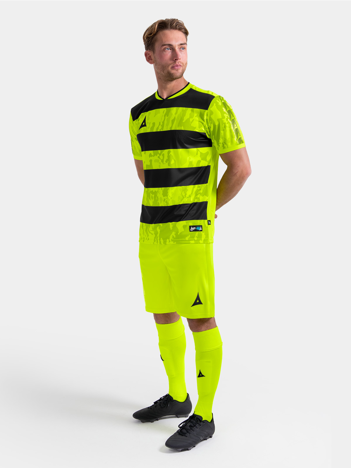 	full body shot of the neon yellow and black pro intent kit, showing the high-visibility uniform on-model.