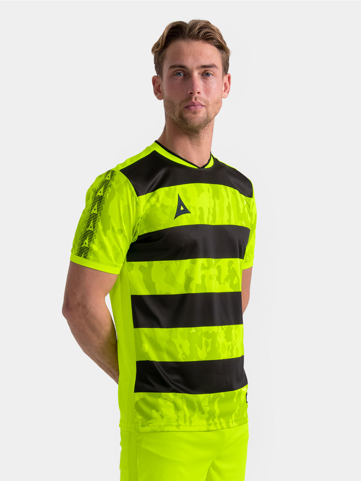 	model wearing the neon yellow and black pro intent jersey, highlighting the bold, high-energy matchday style.