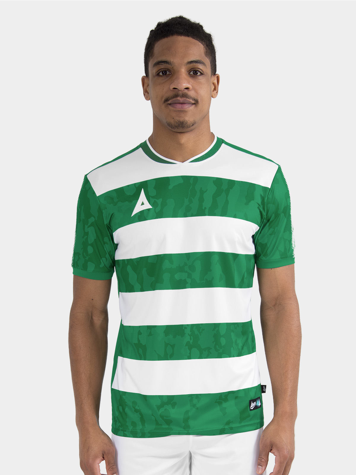 	lifestyle shot of a model wearing the green and white pro intent jersey, focusing on the comfortable athletic fit.