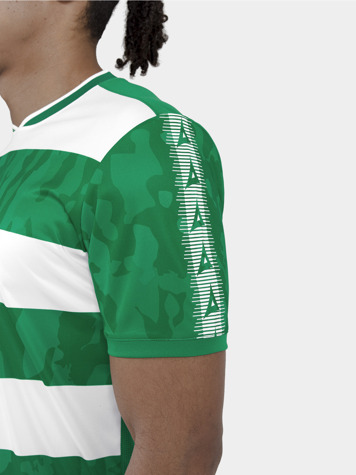 	close-up of the green heritage 'a' sleeve panel and the sublimated camo texture within the hoops.