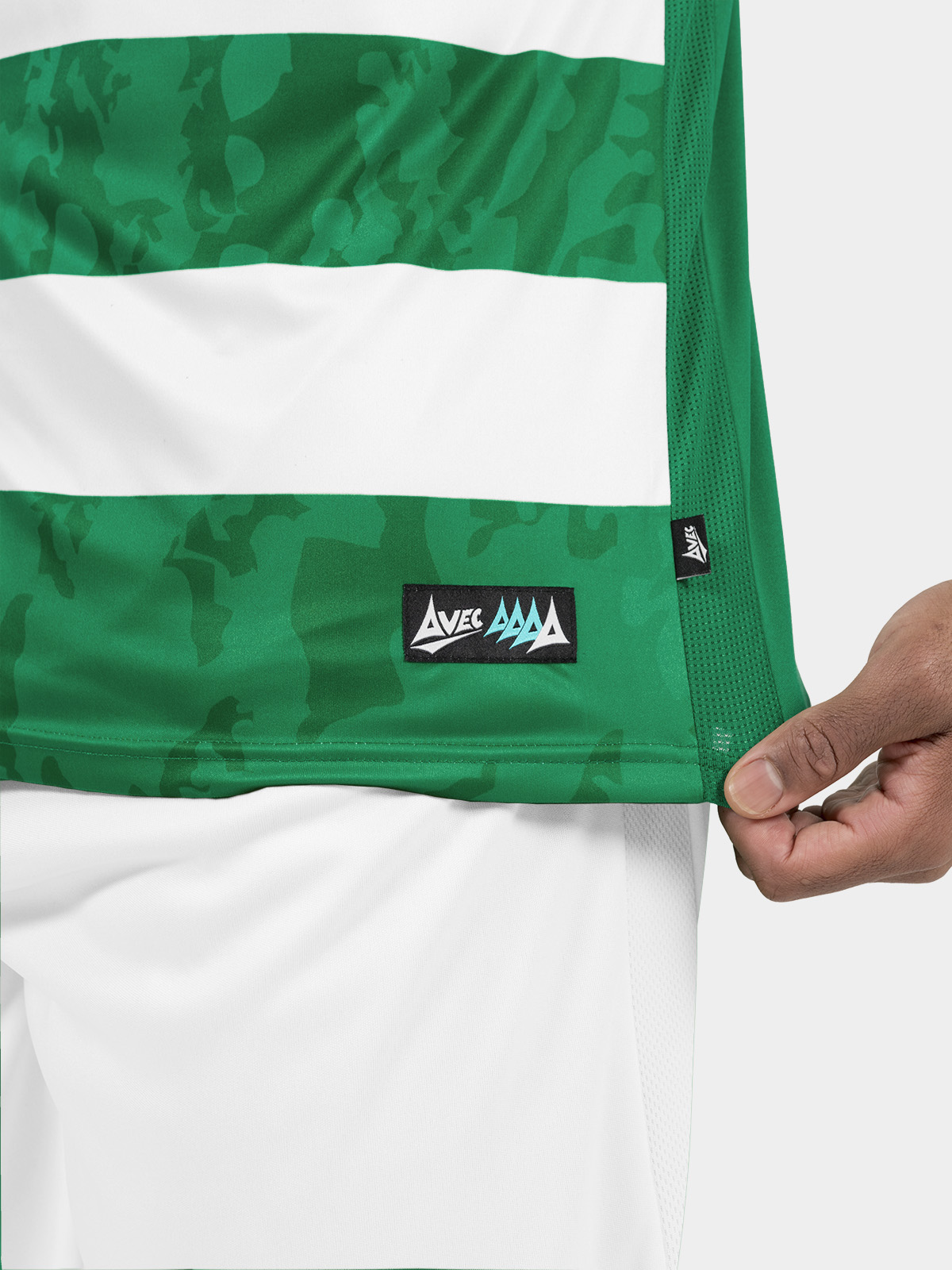 	technical shot of the green and white jersey hem, featuring the official avec id label and breathable mesh.	
