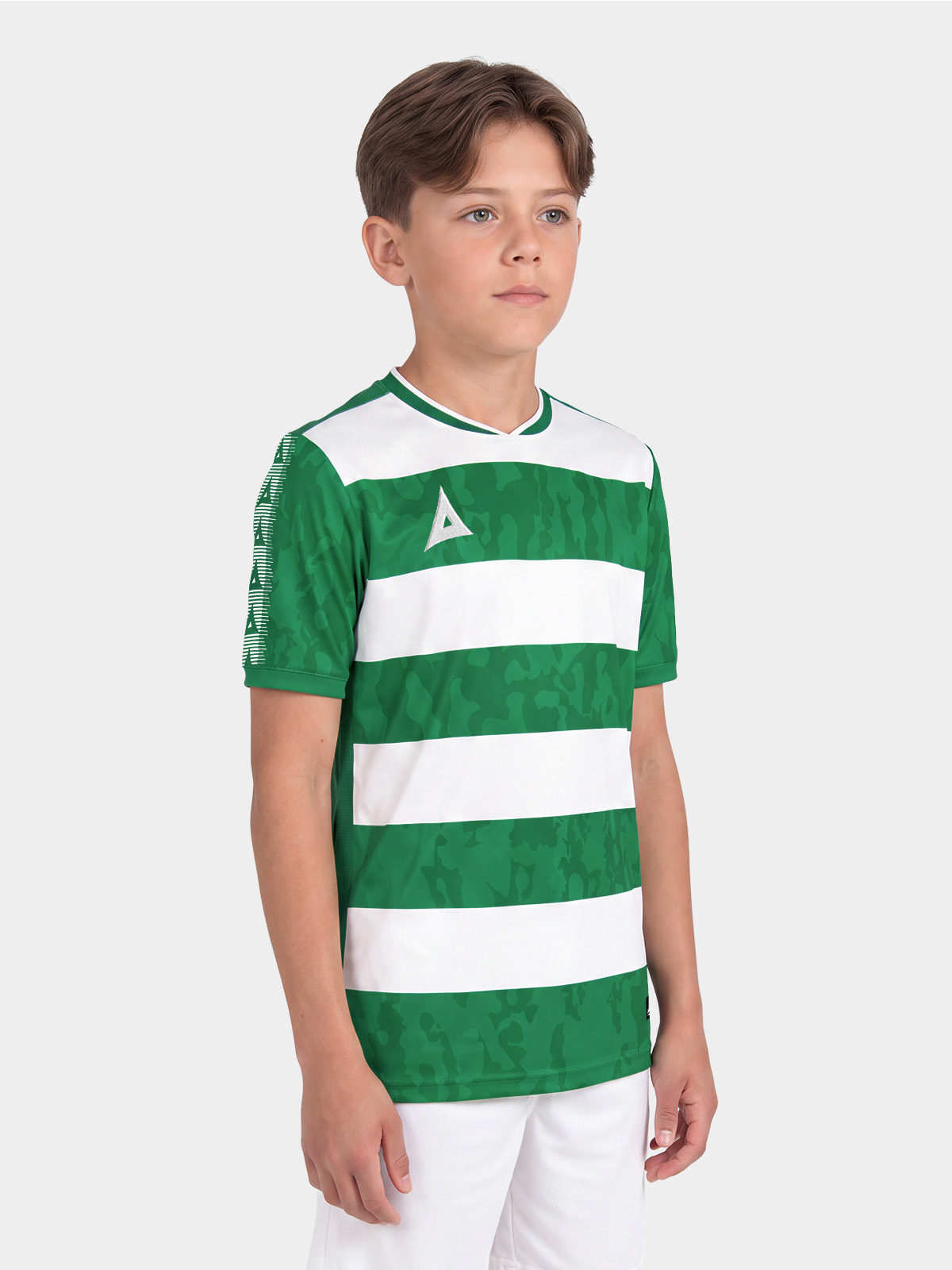 	studio portrait shot of a boy wearing the green and white pro intent jersey, focusing on the comfortable athletic fit.