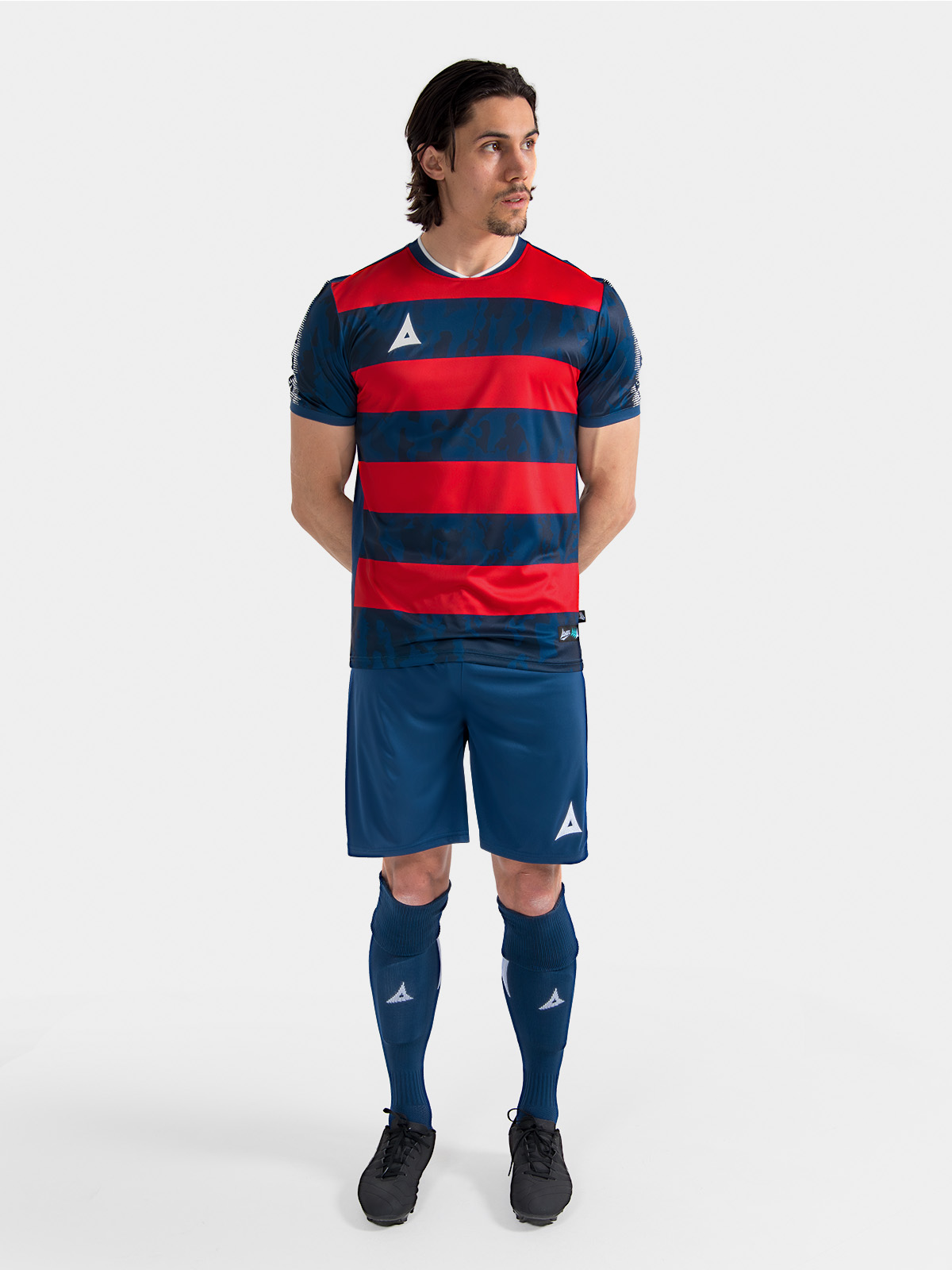 	complete navy and red matchday kit on-model, demonstrating the professional on-pitch appearance.