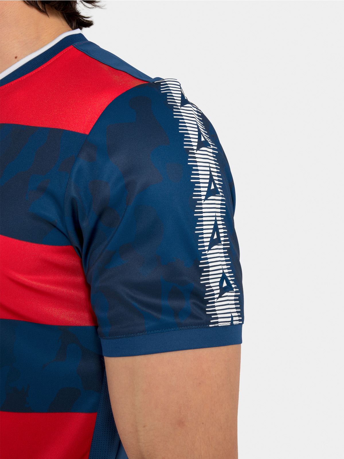 	detailed view of the navy and red jersey shoulder, featuring the iconic repeating avec 'a' branding.