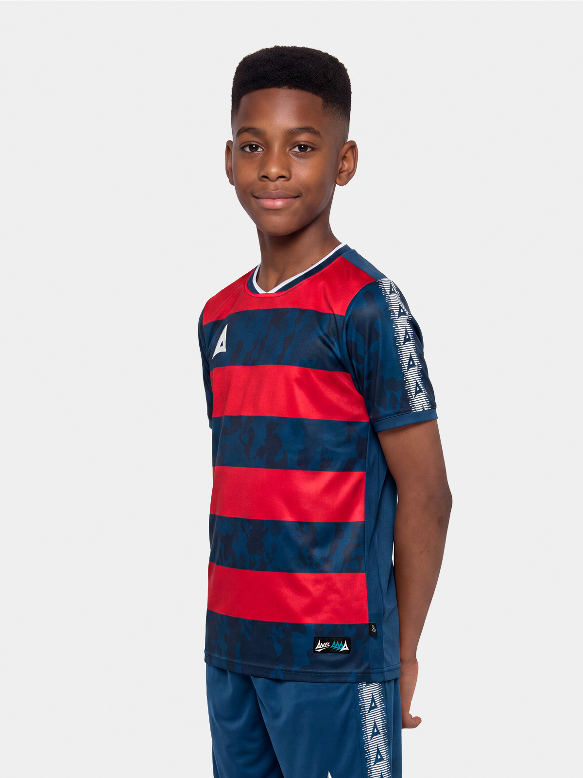 	junior model showcasing the navy and red pro intent hoop jersey, highlighting the modern textured design and pro-fit.