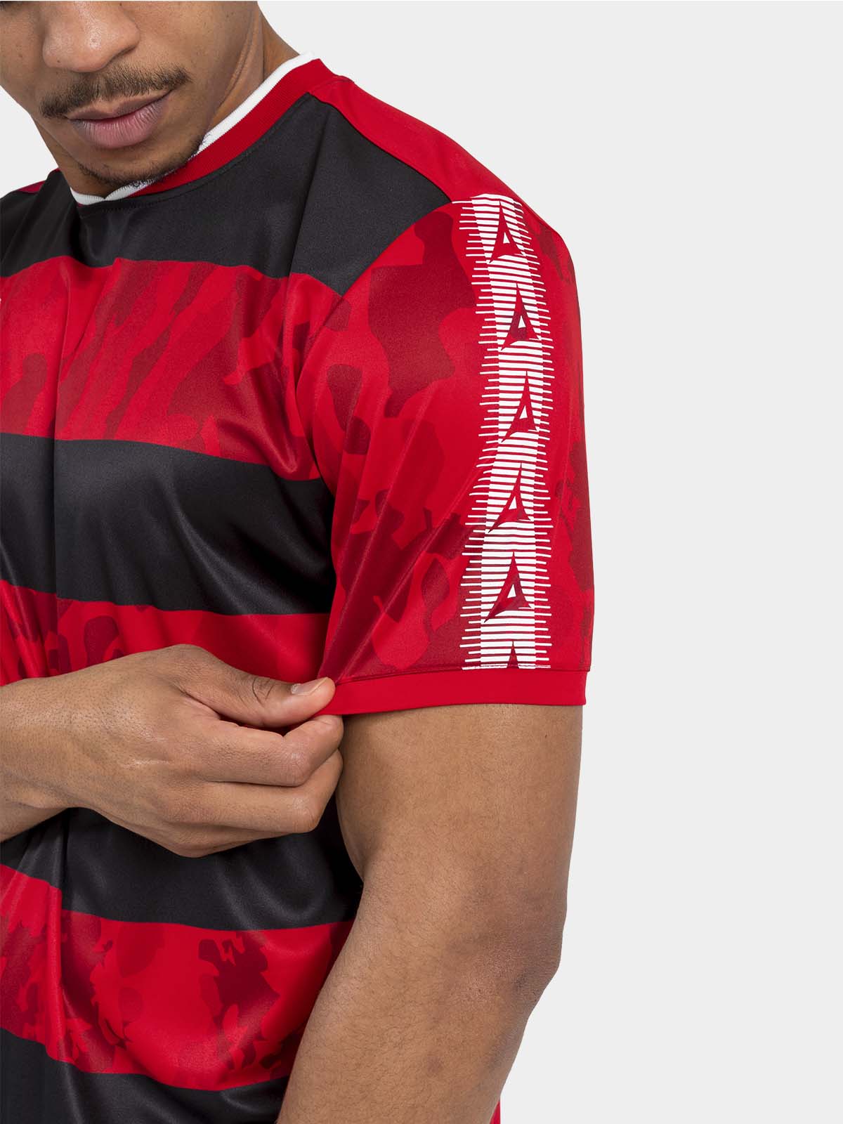 	close-up of the red and black jersey sleeve with the signature heritage contrast panel and camo texture.	